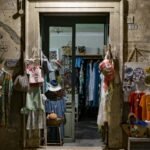 assorted clothes hanging in front of store